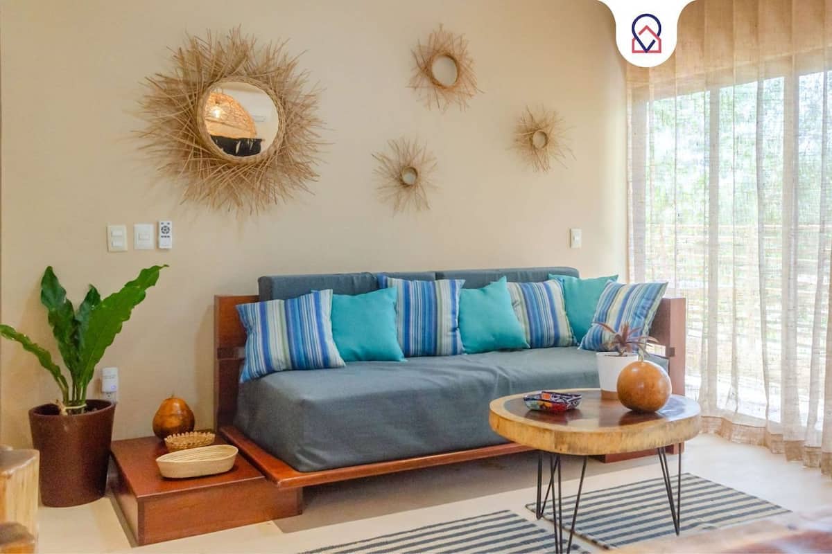 A living room with a sofa, a coffee table, and decorative wall art.