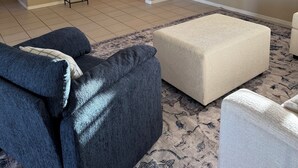 A living room with a ceiling fan, a flat-screen TV, two sofas, and a patterned rug. - Havasu Pool Home with A/C Boat Garage + Toy Parking (Lake Havasu City)