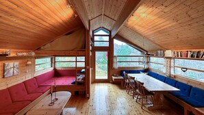 A cabin interior with a loft bed, a dining table, and seating areas. - 3 bedroom cozy home in Tjørhom (Tjørhom)