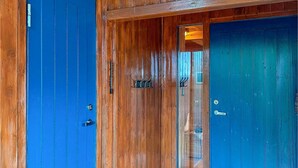 A wooden door with a blue panel and a glass panel. - 3 bedroom cozy home in Tjørhom (Tjørhom)