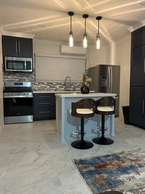 Enjoy casual dining at the kitchen island with appliances and a large window.