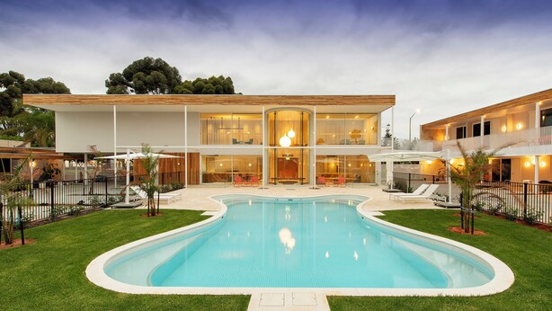 A modern house with a swimming pool, large windows, and a well-maintained lawn. - Kar-Rama Hotel  (Mildura)