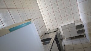 Eine Küche mit weißen Schränken, einer Spüle und einem Herd.