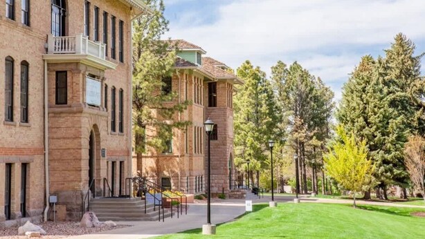 A large brick building with a balcony and a covered walkway.