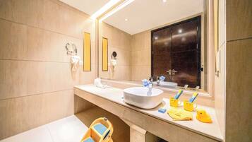A modern bathroom with a large mirror, a sink, and a vanity.