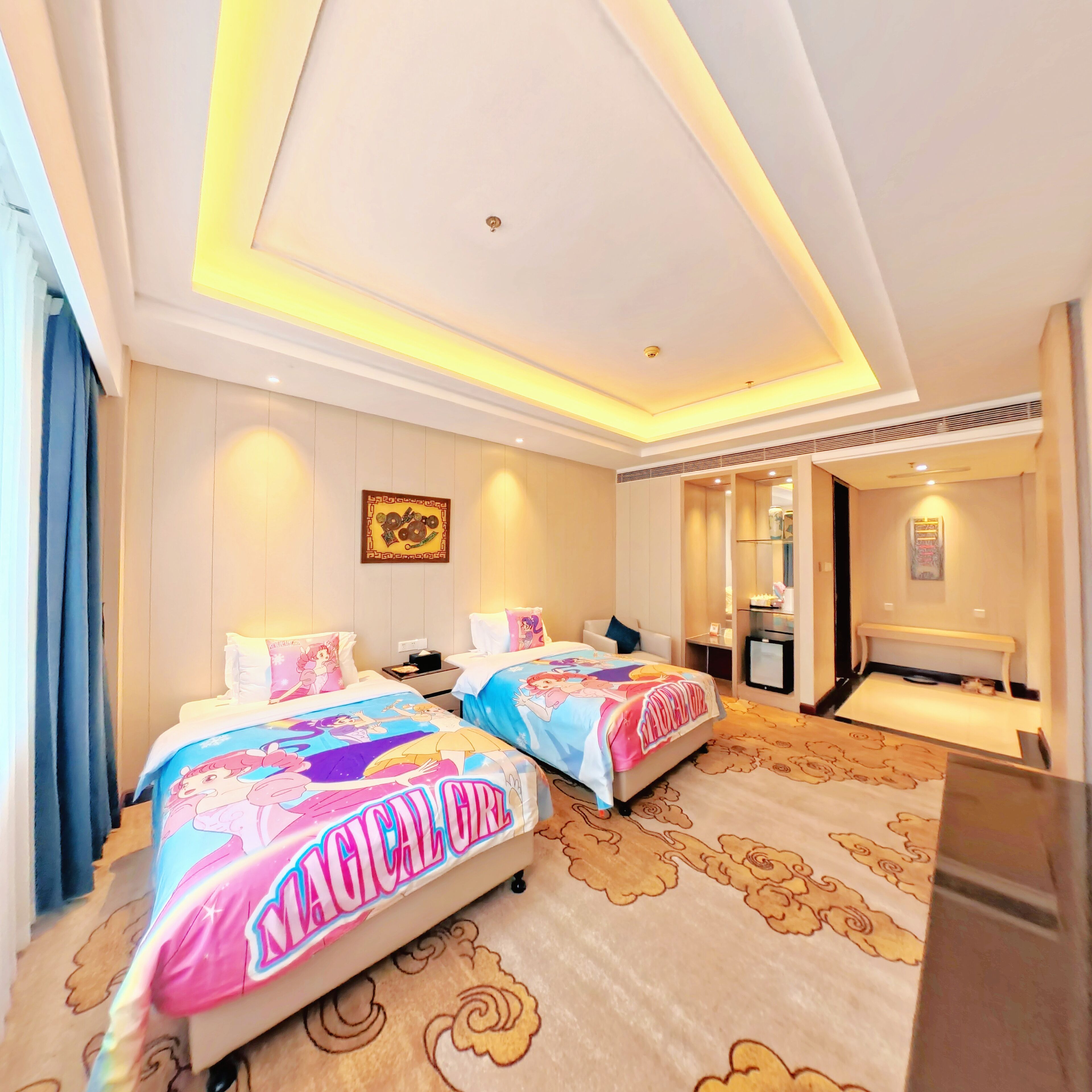 A hotel room with two beds, a desk, and a bathroom.