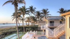 A hotel with a pool, outdoor seating, and a view of the beach and ocean. - Apartment Steps from the Beach! (Deerfield Beach)