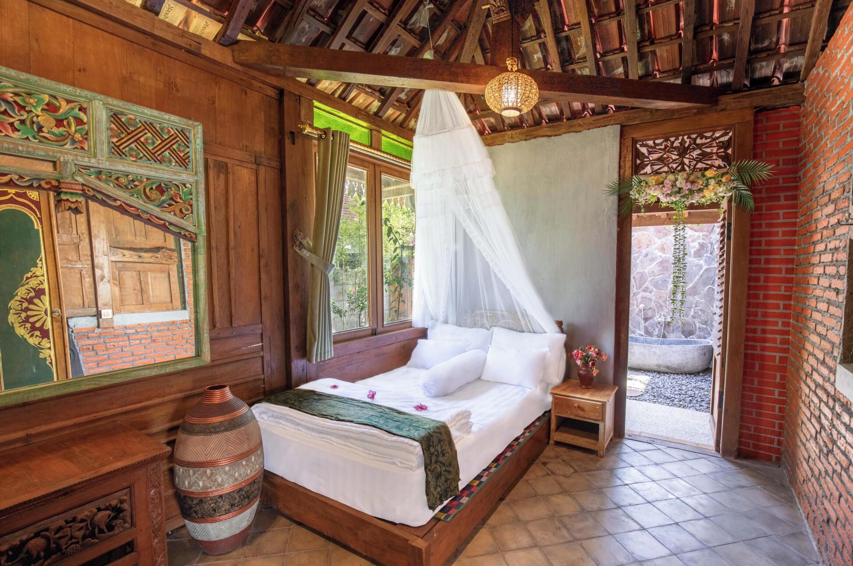 A traditional wooden room with a bed, a large vase, and a decorative wall.