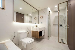 A modern bathroom with a toilet, sink, and shower area. - The Peak M8 Midtown (Ho Chi Minh City)