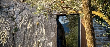 A stone structure with a wooden door leading to an outdoor area.