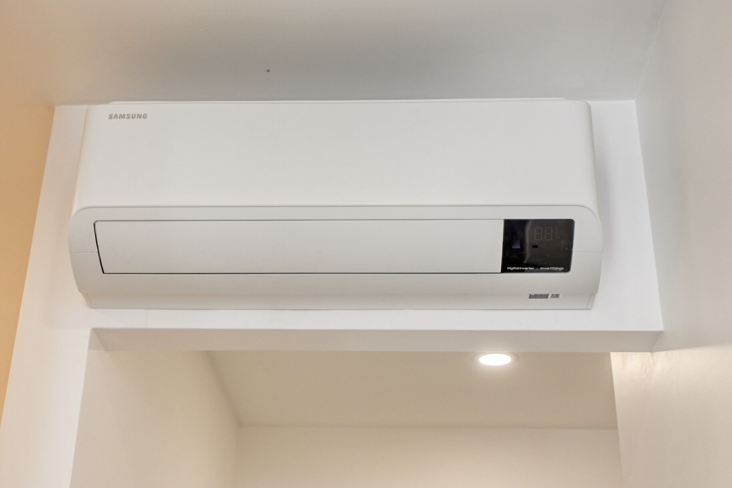 A Samsung air conditioner mounted on a white wall.