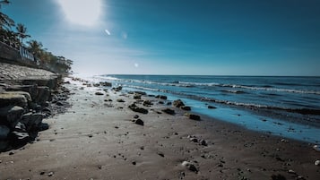 On the beach, black sand