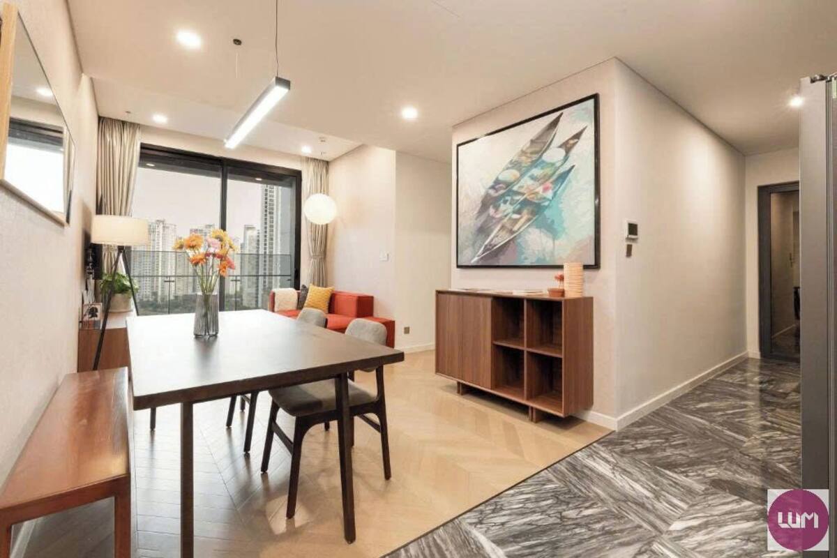 A modern living room with a dining table, sofa, and a large abstract painting.