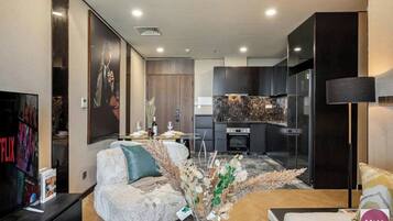 Premium Apartment, 1 Bedroom, Patio, City View | Living area | Foosball, books, music library