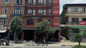 A multi-story building with a prominent sign for 'Annapurna Boutique Hotel'.