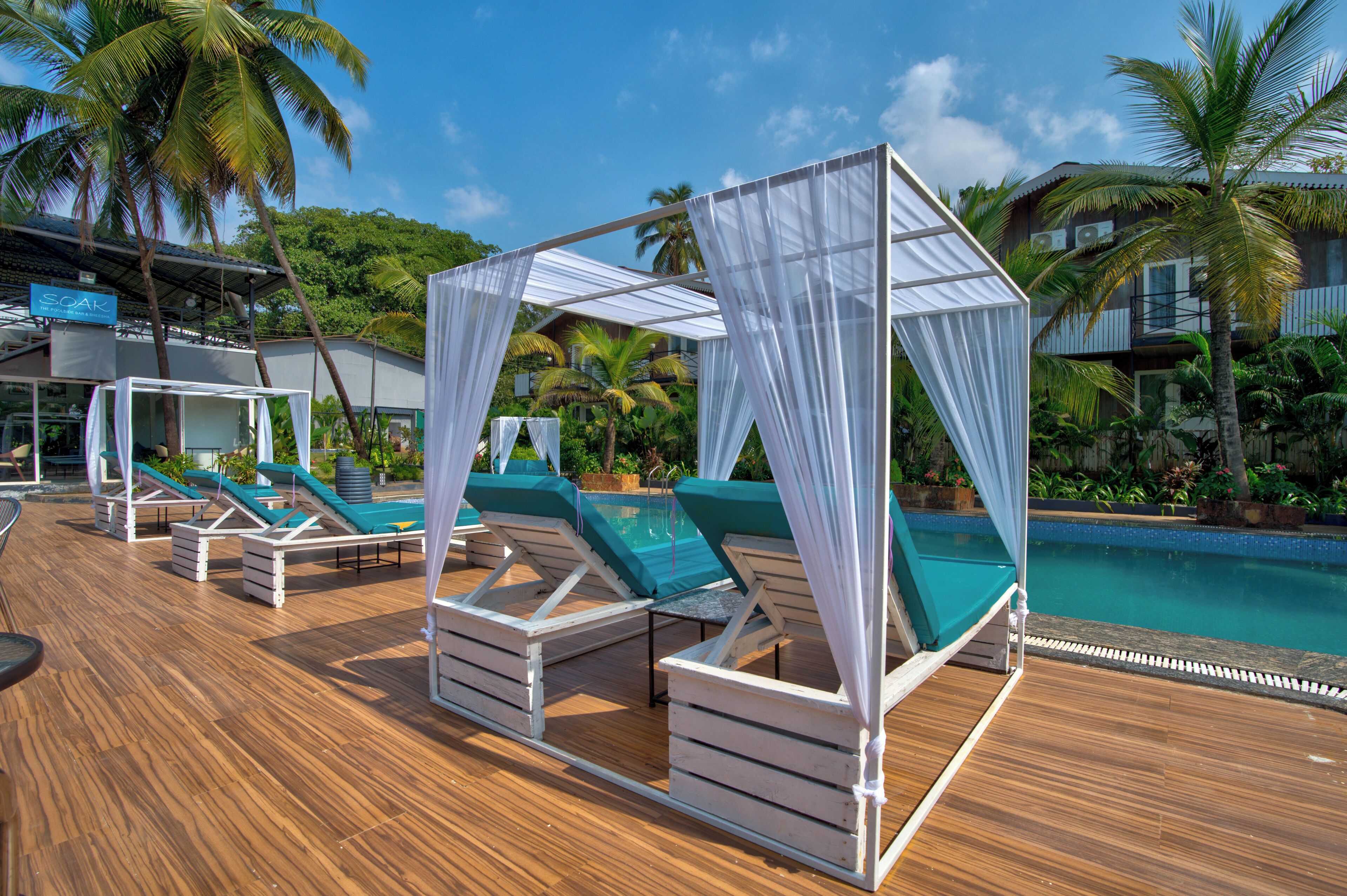 A poolside area with lounge chairs and a canopy structure.