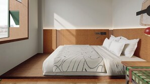 A modern bedroom with a wooden headboard, a large bed with patterned bedding, a bedside table with a lamp, and a window with a view. - PandaSleepHotel (Chengdu)
