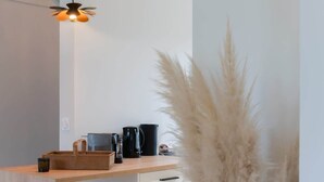 A modern kitchen with a wooden countertop, a hanging light fixture, and a vase of pampas grass. - Ty Mezou - Pretty house on the Gr34 near to the se (Porspoder)