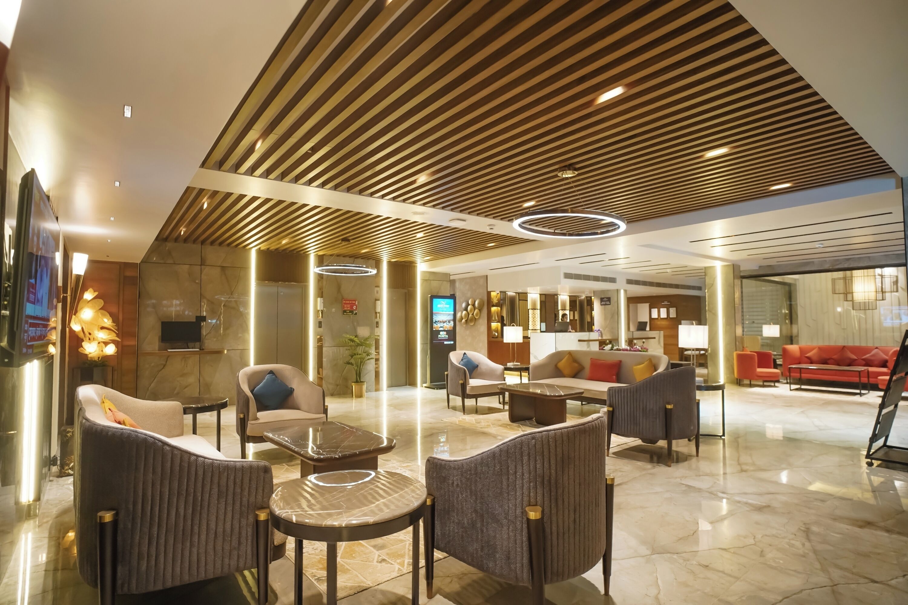 Un hall d’entrée moderne avec un plafond en bois, des sièges confortables et un espace d’accueil.