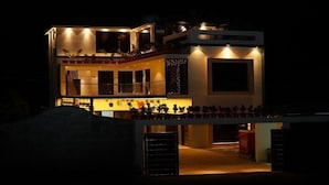 A modern two-story building with a balcony and a large window. - Sun Rays Inn (Yercaud)