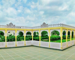 A covered outdoor area with a tiled floor and a white and yellow railing. - The Vaag Udaipur A Luxury Pool Villa in Udaipur (Udaipur)