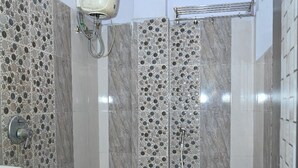 A bathroom with a sink, toilet, and shower. - Hotel Ankitha Grand (Hyderabad)