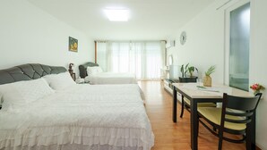A bedroom with two beds, a desk, and a chair. - Taean Norabureo Pet Pension (Taean)