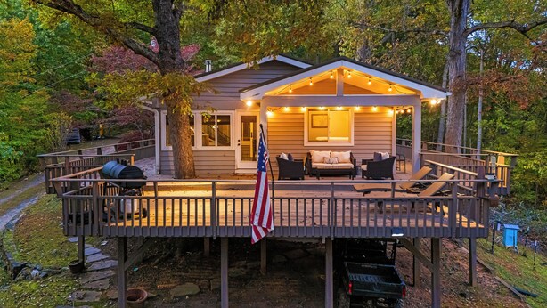 A wooden deck with outdoor furniture and a barbecue grill. - Stunning Views + Arcade Games | Serene Retreat | Cabin in the Sky by AvantStay (Leicester)