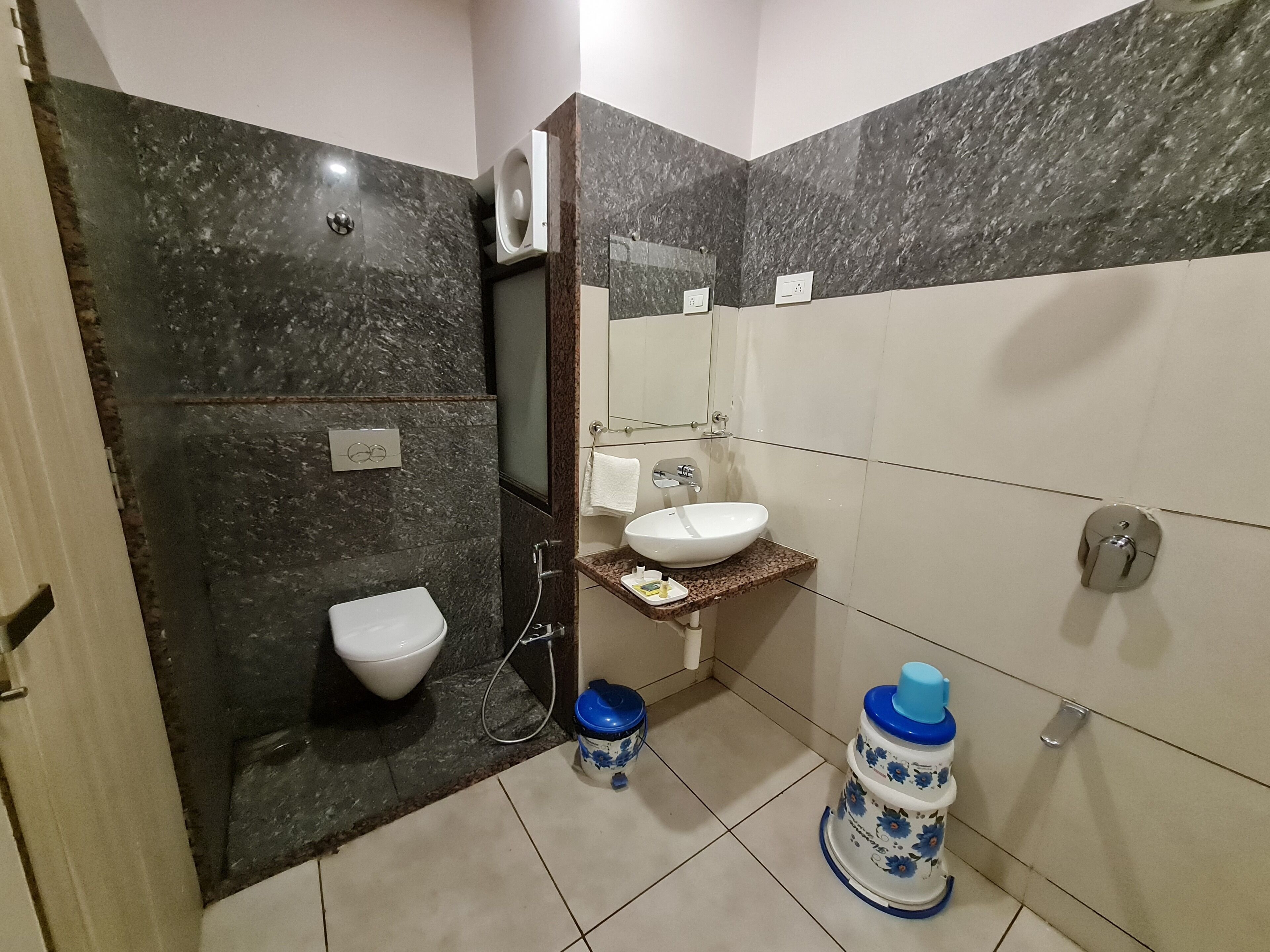 A bathroom with a toilet, sink, and shower.