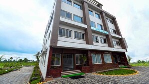 A multi-story hotel with a modern design, featuring a prominent sign on the facade. - HOTEL SHIV SHAKTI (Goharganj)