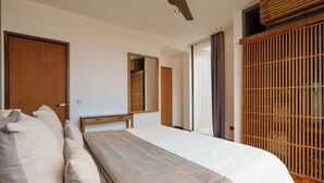 Un dormitorio con cama, armario de madera, espejo y ventilador de techo.