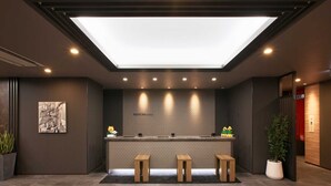 A modern reception area with a skylight, a reception desk, and three wooden stools. - Hotel Route Inn Hiratsuka Eki Kitaguchi (Hiratsuka)