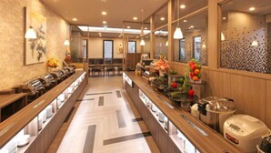 A modern hotel lobby with a long reception desk, seating area, and a buffet setup. - Hotel Route Inn Hiratsuka Eki Kitaguchi (Hiratsuka)