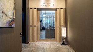 A modern entrance to a restaurant with a sign reading "Restaurant NAGOMI". - Hotel Route Inn Tonami Inter (Tonami)