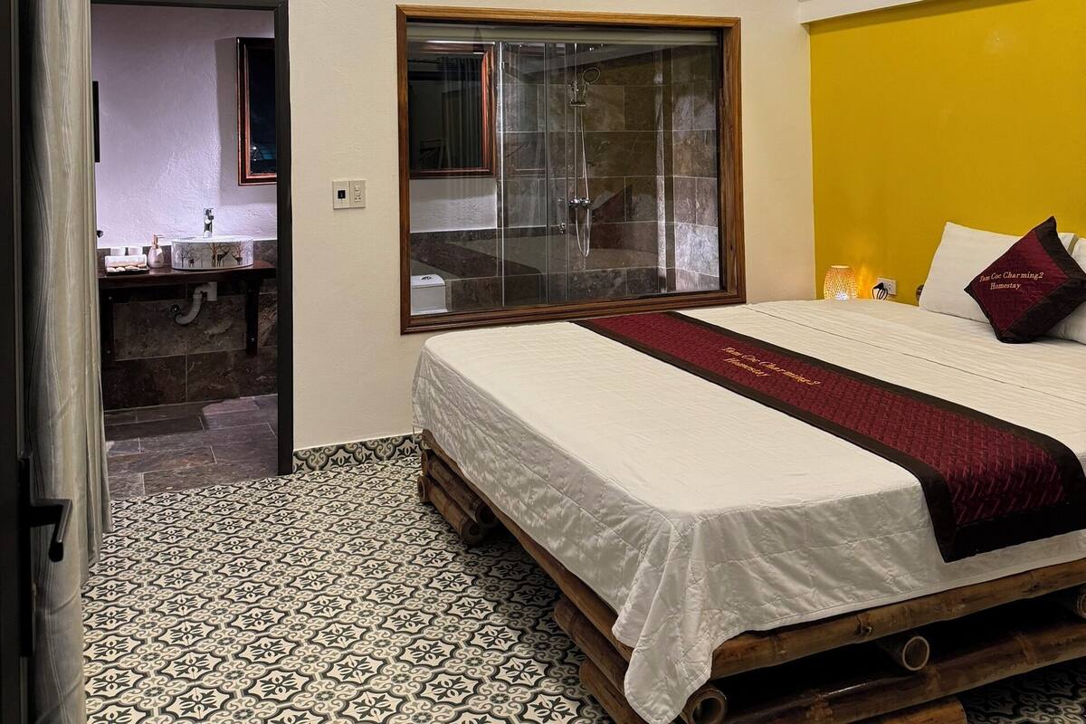 Ein Schlafzimmer mit Bett, Bad und Duschbereich.