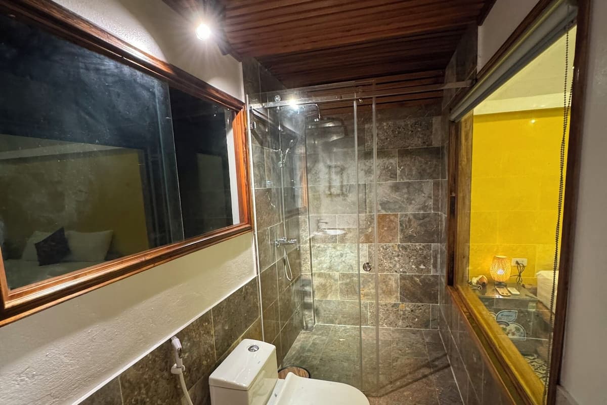 Ein Badezimmer mit Toilette, Waschbecken und Duschbereich.