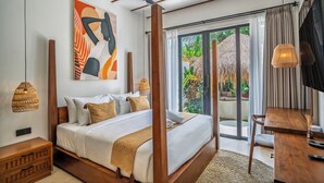 A bedroom with a bed, bedside table, and a ceiling fan. - Malta Villa by Betterplace (Ubud)