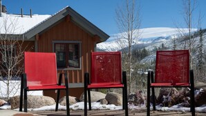 A wooden cabin with two red chairs in front. - Hot Tub | Mountain Views | Steps to Trails (Winter Park)