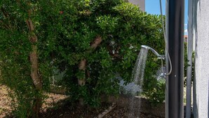 A garden with a water feature, including a fountain and a hose.