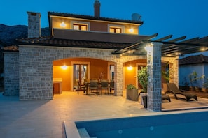 Enjoy a relaxing stay in this charming two-story building with a pool and outdoor seating area.