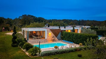 Outdoor pool, a heated pool, pool umbrellas, pool loungers