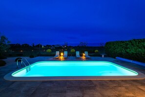 Outdoor pool, a heated pool, open open 24 hours a day, pool loungers
