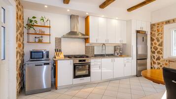 Villa | Private kitchen | Oven, electric kettle, toaster