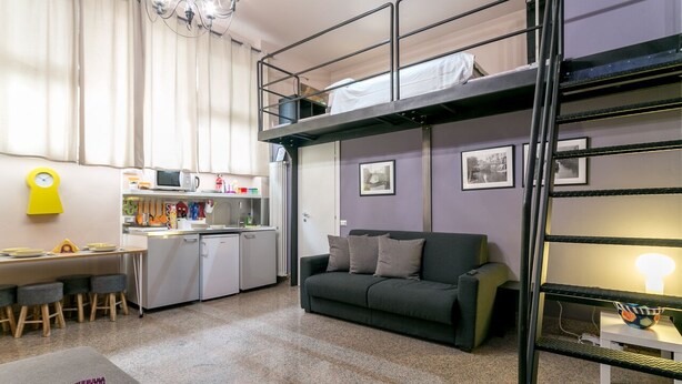 A compact studio apartment with a kitchenette, a dining area, a sofa, and a bunk bed. - Spacious Studio in via Sammartini 33 (Milan)