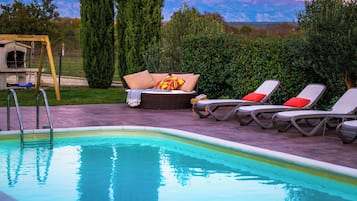 Outdoor pool, a heated pool, pool umbrellas