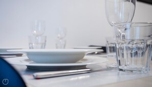 A table set with a white plate, a clear glass, and a glass of water. - Italianway - Martinetti 19 (Milan)