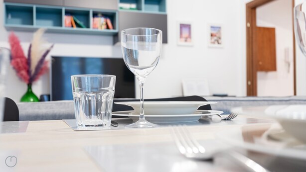 A dining table with a glass of water and a wine glass, a fork, and a napkin. - Italianway - Martinetti 19 (Milan)