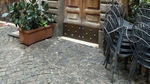 A building with a large wooden double door, a no entry sign, and a number 26 sign. - Navona "The Corner"  (Roma)