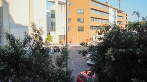 A multi-story building with a modern architectural design, featuring large windows and a mix of brick and glass facades. - Central House near the airport (Fiumicino)