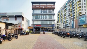A hotel named Regal Heaven with a visible Yamaha store and a row of parked motorcycles.